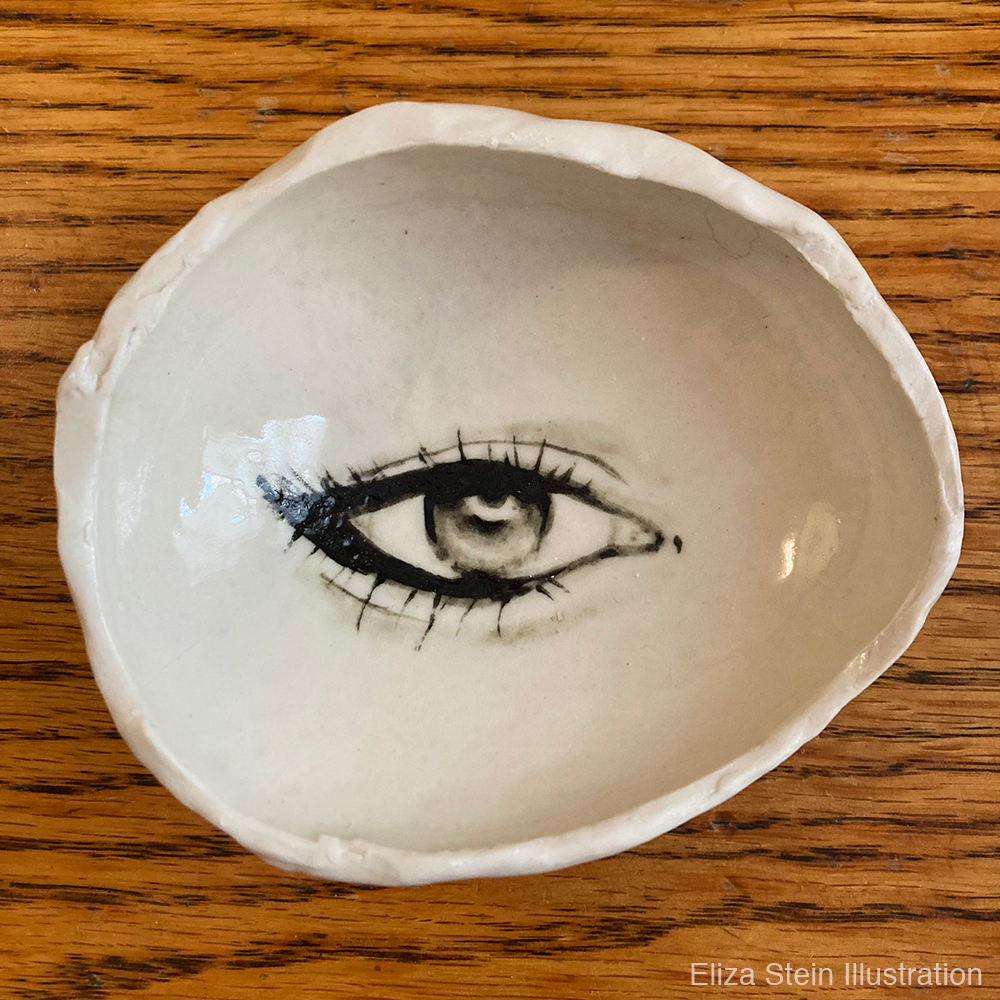 stoneware dish with eye painted in the center