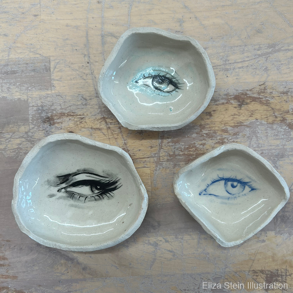 three ceramic dishes with eyes painted in their centers