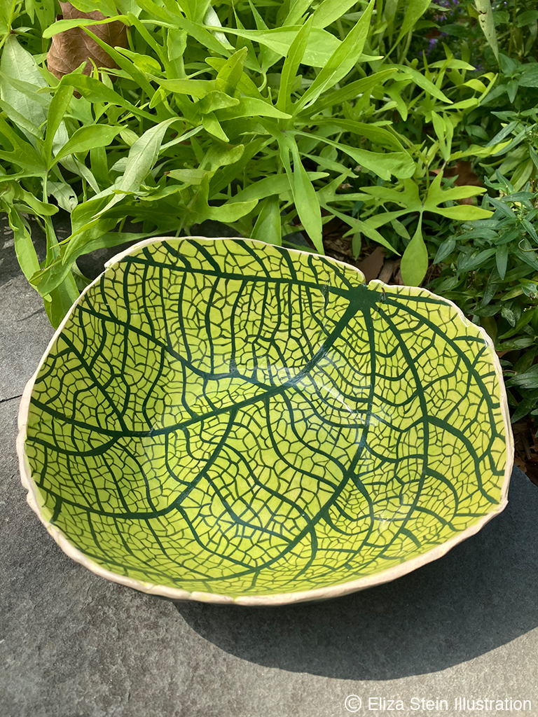bird's eye view of ceramic bowl painted to look like a leaf's veins magnified